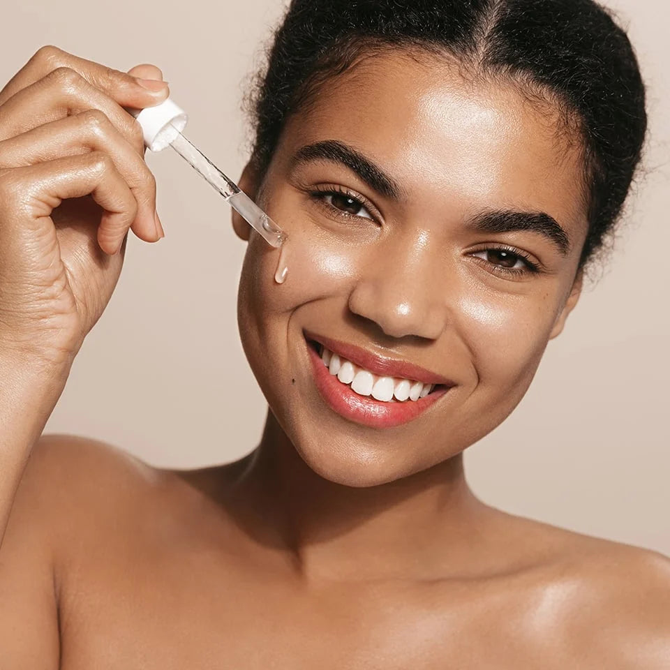 Model applying RemeVerse skincare product to face