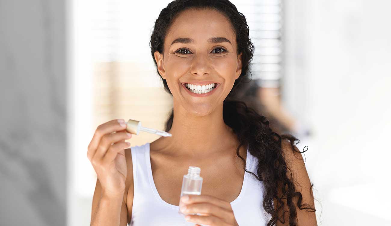 Woman holding skincare serum