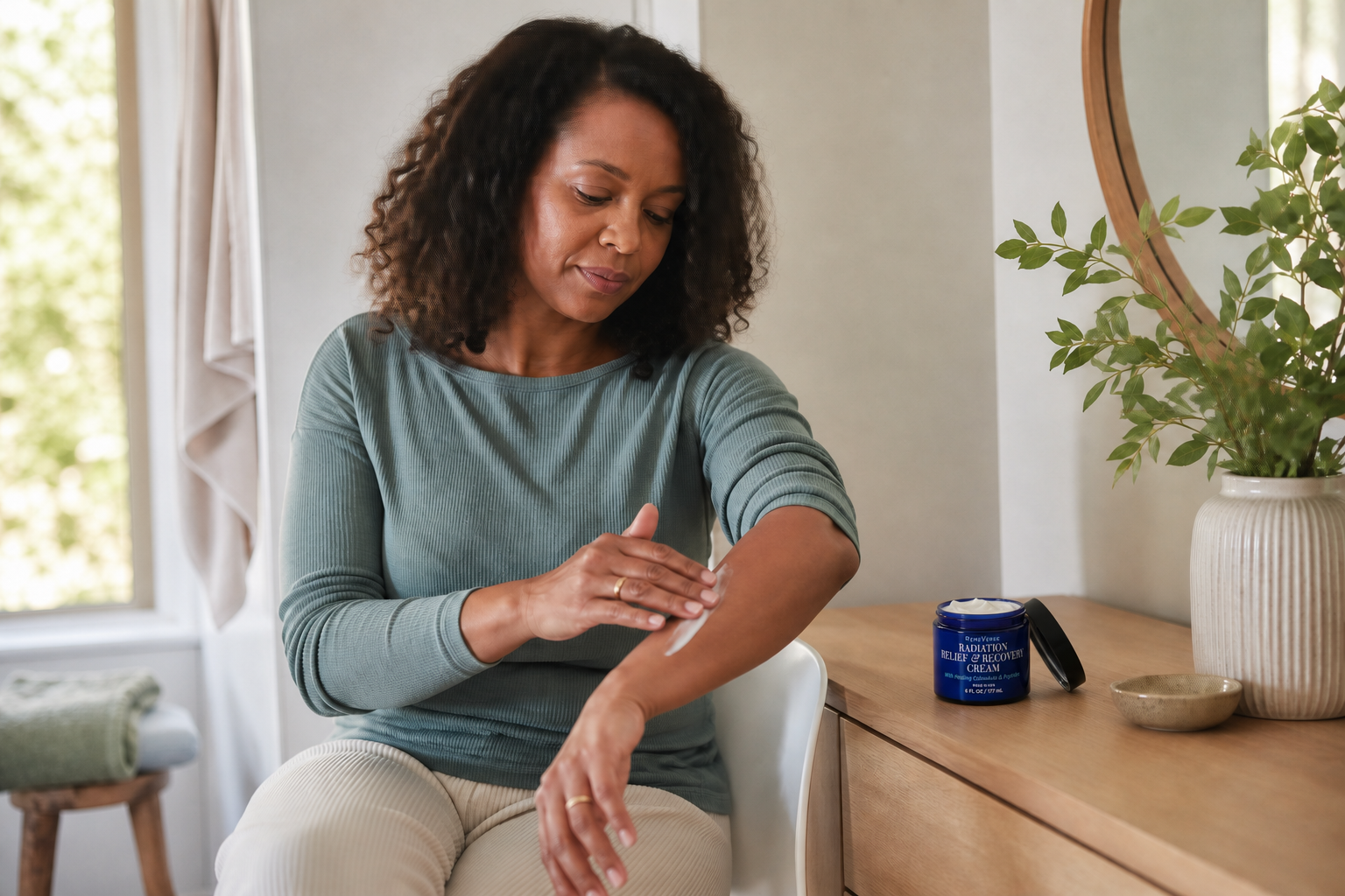 Woman applying Radiation Relief Recovery Cream to her forearm